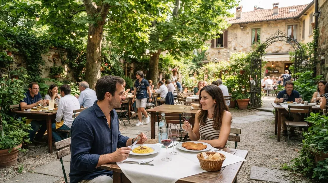 el jardín centenario de Osteria del Binari con mesas bajo los árboles, sombra moteada y un ambiente tradicional de almuerzo milanés